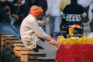 Traditional street vendor selling sliced pineapples in public without visible food protection, common in informal markets